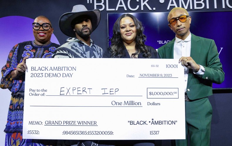 Black Ambition CEO Felecia Hatcher, Leonard Creer, Antoinette Banks and Pharrell Williams pose at the Black Ambition event holding a giant facsimile check for $1 million